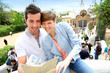 Couple in Barcelona reading travel guide