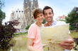 Couple reading map in front of the Sagrada familia church