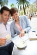 Couple in Barcelona sitting at restaurant table in Plaza Real