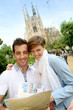 Couple reading travel guide by the sagrada familia church