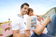 Tourists reading travel book in Guell Park, Barcelona