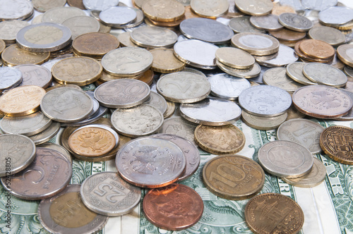 Photo: pile of different coins on isolated background pile of different coins on isolated background