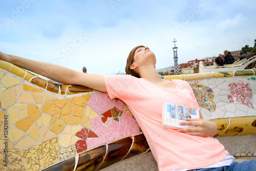 Photo: Young woman relaxing in Guell park Young woman relaxing in Guell park
