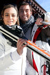 Photo: Couple going skiing on a sunny winter's day Couple going skiing on a sunny winter's day