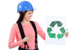 Builder pointing to recycle sign