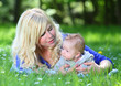 Photo: Young mother with her little boy in the park together. Young mother with her little boy in the park together.