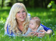 Photo: Young mother with little boy in the park together. Young mother with little boy in the park together.