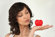 Woman with a heart laying on the palm of her hand