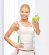 sporty woman with apple and measuring tape