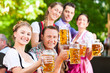 Foto: Im Biergarten - Freunde trinken Bier in Bayern Im Biergarten - Freunde trinken Bier in Bayern
