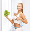 sporty woman with lettuce showing abs
