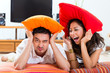 Asian couple at home in their living room