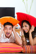 Asian couple at home in their living room