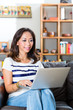 Young Asian woman at home on the sofa
