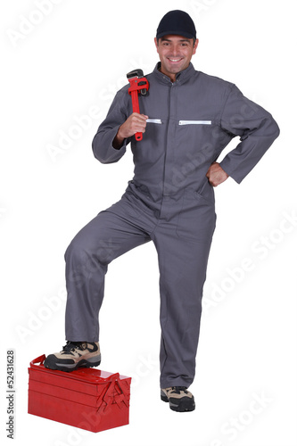 Photo: Man with a wrench and toolbox Man with a wrench and toolbox