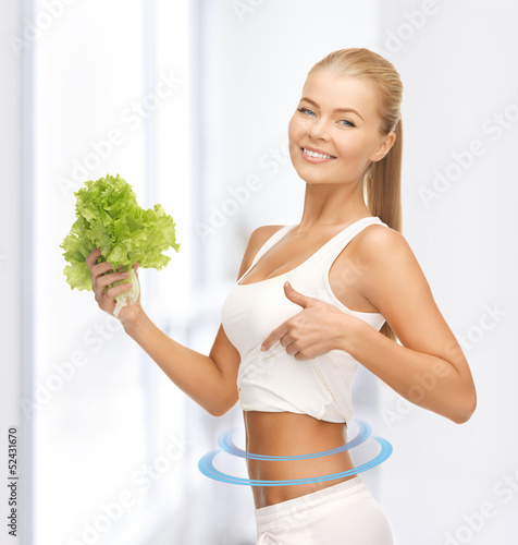 Photo: sporty woman with lettuce showing abs sporty woman with lettuce showing abs