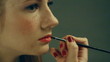 Beauty woman having her made up by stylist
