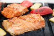 Salmon steaks being fried on grill