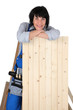 Photo: Woman carpenter leaning on a plank Woman carpenter leaning on a plank