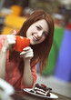 Style redhead girl with cake and cup
