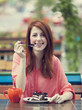 Style redhead girl with cake and cup