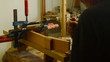Luthier prepares wood for a guitar mast