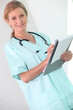 Photo: A female doctor writing on a clipboard and smiling at us. A female doctor writing on a clipboard and smiling at us.