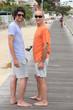 Grandfather and grandson walking along the beach