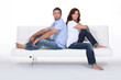 Couple back to back on white sofa