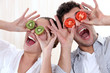 Covering his eyes with a couple slices of kiwi and tomato