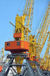 Port cargo crane over blue sky background