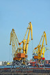 Port cargo crane over blue sky background