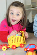 Young child playing with her toys