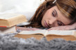 Photo: Female teenager asleep on a book Female teenager asleep on a book