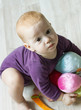 Top view of cute baby playing with toys and looking up
