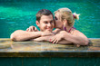 Photo: Kissing and relaxing in a swimming pool Kissing and relaxing in a swimming pool