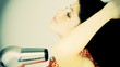 Happy female model blow drying long hair
