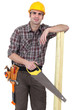 Photo: Builder with wood and handsaw Builder with wood and handsaw