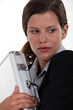 Foto: Businesswoman nervously holding metal briefcase Businesswoman nervously holding metal briefcase