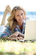 Photo: Woman on laptop outside Woman on laptop outside