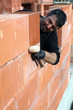 Man building a brick wall