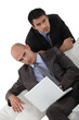 Photo: Two businessmen on a sofa Two businessmen on a sofa