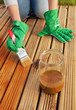 Applying protective varnish on a patio wooden floor