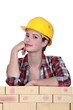 Thoughtful female construction worker