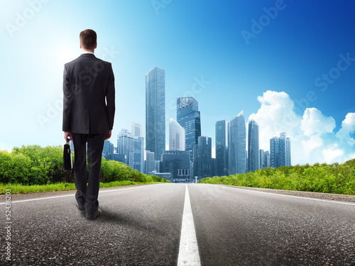 Photo: business man walking on the road business man walking on the road