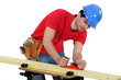 Foto: Man planning plank of wood Man planning plank of wood