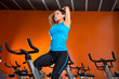 Aerobics spinning woman stretching exercises after workout
