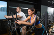 elliptical walker trainer man and woman at black gym