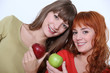 Women holding apples