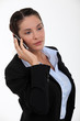 Photo: Businesswoman talking on her mobile phone Businesswoman talking on her mobile phone